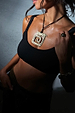 Deloris Mermaid Necklace featuring an engraved brass pendant on an adjustable black leather cord, styled on a model.