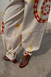 Snake Tie Side Trousers in white cotton twill with red snake and yellow star motifs and multi-wear ankle ties.