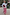 Thumbnail for Dusky Pink Snake Balloon Trouser with snake and swirl motifs, styled with a white ruffled blouse on a sandy beach.