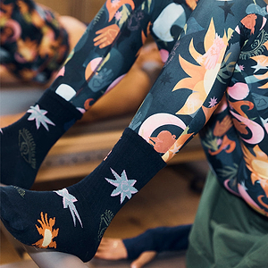 Black cotton Element crew socks with sun and star prints, styled with matching multi-coloured leggings.