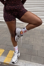 White Element crew socks with colourful sun graphics, styled with leopard print shorts and silver trainers.