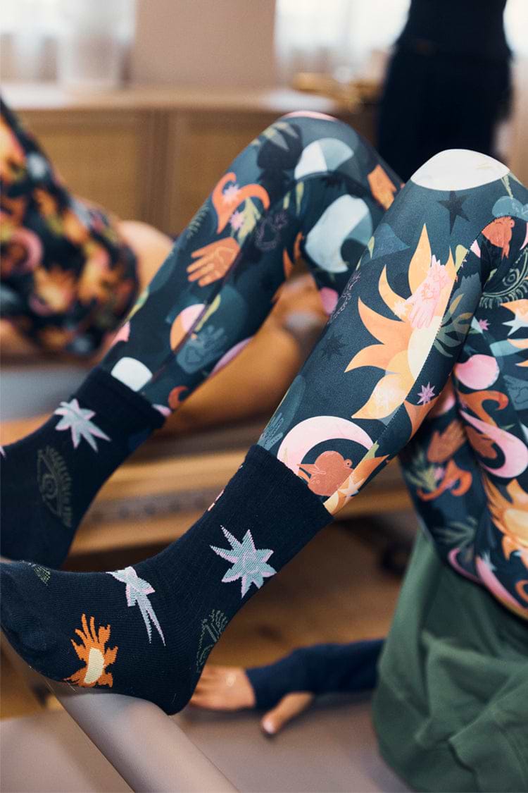 Element cotton crew socks featuring colourful celestial prints, worn with matching patterned activewear.