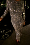 Gunmetal Sequin Soho Dress with long sleeves and a shimmering finish in a motion-blurred party setting.