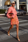 Pink Sol Beaded Wrap Skirt with hand-embroidered sun print and gold sequins, styled for a street style vacation look.