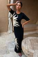 Thumbnail for Black Sol Dorris Skirt and matching top with a hand-painted sun print, styled as a co-ord in a courtyard.