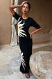 Black Sol Dorris Skirt and matching top with a hand-painted sun print, styled as a co-ord in a courtyard.