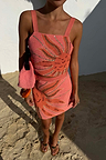Pink Sol Beaded Wrap Skirt and matching top co-ord with a sequined sun print, styled for a beach vacation.