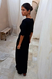 Black Sol Dorris Skirt in viscose-stretch jersey, styled as a co-ord on a model in a stone patio setting.