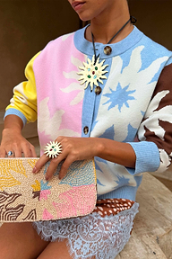 Soleil Hollie Cardigan featuring iconic pastel sun motifs and soft touch knit, styled with a beaded clutch.