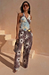 Multi-wear Soleil Wrap Top in chocolate with iconic sun motifs, styled with matching trousers for a summer co-ord.
