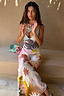 Abstract Soleil Emilia Dress featuring a pastel sun print and panelled design, worn by a model in a summer setting.