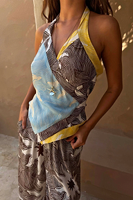 Brown Soleil Wrap Top with sun motifs and blue and yellow accents in a multi-wear handkerchief silhouette.