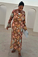 Star Fawn Aria Mesh Dress in brown with celestial motifs and flared sleeves, worn by a model against white arches.