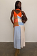 Multi Stripe Bea Dress in orange and blue with a pleated polka dot skirt and matching neck scarf on a model.