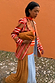 Longline Multi Stripe Blazer in red and blue styled with a tan suede clutch and a patterned maxi dress.