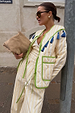 Butter Yellow Stripe Quilted Jacket with green trim and blue tassels, worn by a model in an outdoor street setting.