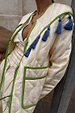 Butter Yellow Stripe Quilted Jacket with green trim and blue tassels along the shoulder.