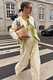 Butter Yellow Stripe Quilted Jacket with green trim and blue tassels, styled as a co-ord on a zebra crossing.