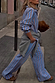 Blue Cotton Stripe Jogger with red pinstripes, styled with a matching shirt and grey sweater tied at the waist.