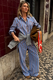 Blue Cotton Stripe Jogger with red pinstripes, paired with a matching shirt and grey sweater tied at the waist.
