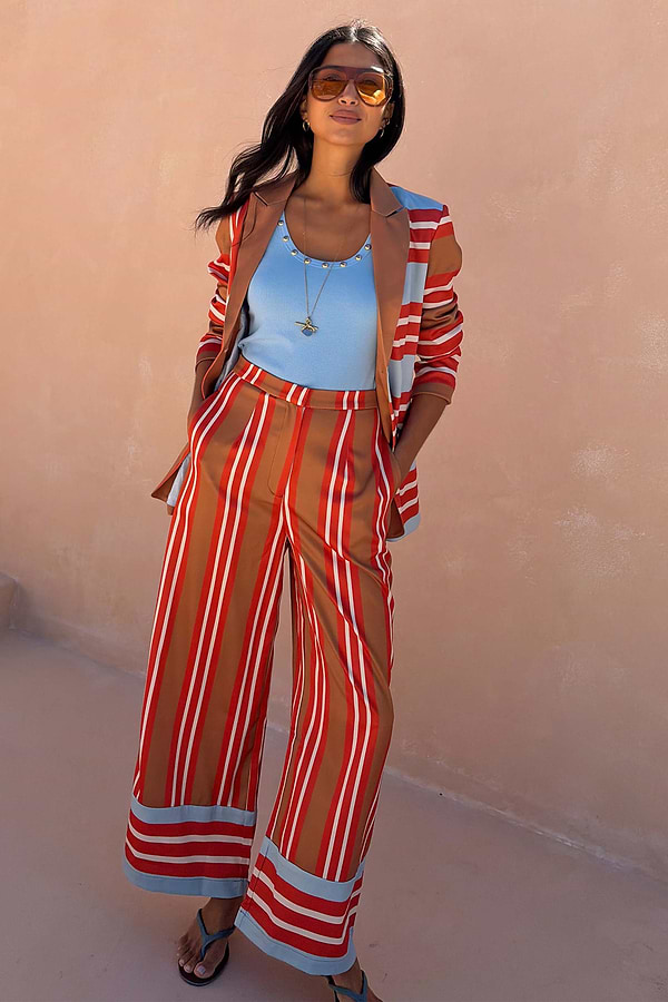 Multi Stripe Marnie Trousers in a red and blue wide-leg silhouette, styled as a co-ord for feel good dressing.