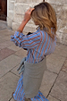 Blue Cotton Stripe Miley Shirt with red pinstripes, styled as a co-ord with a grey jumper tied at the waist.