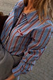 Blue Cotton Stripe Miley Shirt with red pinstripes and red fish embroidery in a London street setting.