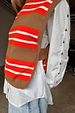 Multi Stripe Tank Top in tan and red knit, layered over a white shirt with gold button sleeve details.
