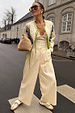 Wide leg Butter Yellow Stripe Suki Trousers styled as a matching co-ord suit for a London street look.