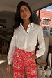 White Marley Shirt with gold studs on sleeves and shoulders, worn with red bandana jeans.