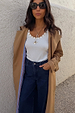 White Studded Rib Vest with gold stud detailing, styled with a camel trench coat and dark denim jeans.