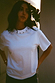 Thumbnail for White cotton T-shirt with silver stud detailing around the neckline and a relaxed fit on a model.