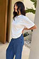Thumbnail for White Studded T-Shirt in relaxed-fit cotton with silver neckline studs, styled with blue denim jeans.