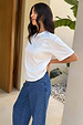 White Studded T-Shirt in relaxed-fit cotton with silver neckline studs, styled with blue denim jeans.
