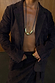 Chocolate Suede Jacket with notched lapels and buttoned cuffs, styled with gold jewellery for a premium London look.