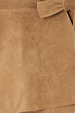 Iconic Tan Suede Mini Jaspre Skirt close-up highlighting the wrap waist tie and texture.