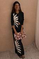 Black Sol Alexa Cardigan in a ribbed knit with a hand-painted sun print, worn with the matching midaxi skirt co-ord.