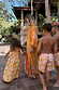 Yellow cotton girl's sun dress with a sun print and shirred top, part of a matching family vacation outfit.