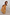 Thumbnail for NFD Kids yellow cotton maxi sun dress with a vibrant sun print and shirred top, worn by a young girl.