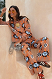 Tan Sun Trousers in a soft stretch knit with a sun and swirl motif, styled as a co-ord set on a model.