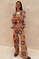 Thumbnail for Tan Sun knit trousers with sun and swirl motifs, styled as a co-ord. Model is 5ft4” and wears size M.