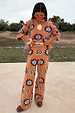 Tan Sun Trousers with sun motifs in stretch knit, styled as a co-ord on a 5ft4 model wearing size M.