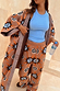 Thumbnail for Tan Sun Trousers in a soft stretch knit with sun motifs, worn with a matching cardigan and a blue top.