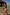 Thumbnail for Yellow Sun Swim Shorts with a sun print and drawstring waist, worn by two boys walking in shallow beach water.