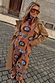Tan Sun Copenhagen Jumper with sun and swirl motifs, styled with matching trousers and a long camel trench coat.