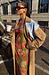 Tan Trench Coat with gold studs and pinstripe lining, a statement staple layered over a vibrant printed dress.