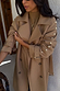 Tan Trench Coat with gold studs along the sleeve and buckled cuffs, a versatile statement staple.