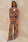 Tan Sun Copenhagen Jumper and trousers co-ord featuring orange and blue Mediterranean motifs on a soft tan knit.