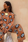 Tan Sun Copenhagen Jumper and matching knit trousers with hand-painted sun and swirl motifs.