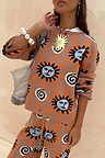 Tan Sun Copenhagen Jumper with Mediterranean-inspired sun and swirl motifs, styled as a soft knit co-ord.